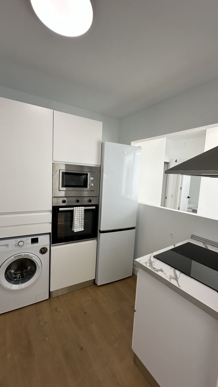 Cocina de la planta baja con frigorífico, horno y placa de inducción
